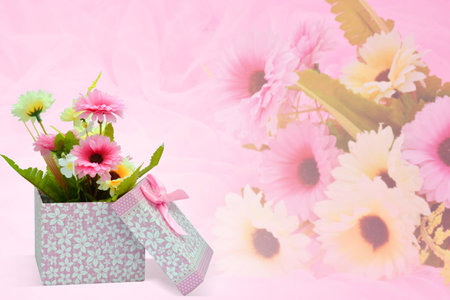 Beautiful romantic gift box and fake flower on pink background.の写真素材