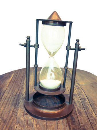 vintage sandglass on wooden table
