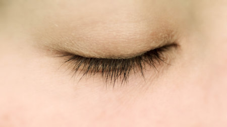 Close up asian female brown close eyeの写真素材