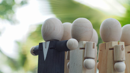 wooden doll of businessman as teamwork with the leader on the front, business leadership and teamwork conceptの写真素材
