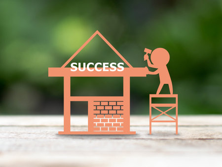 paper art man building house over blur nature background, business success conceptの写真素材