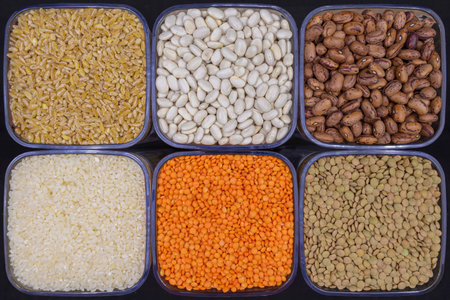 Various legumes and grains. Beans, kidney beans, green lentils, red lentils, rice and wheat.の写真素材