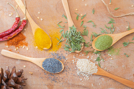 Top view various spices on wooden spoons. Aromatic foodstuffs.