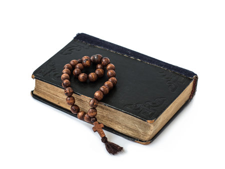 Rosary on the Bible isolated on a white background. Holy book.の写真素材