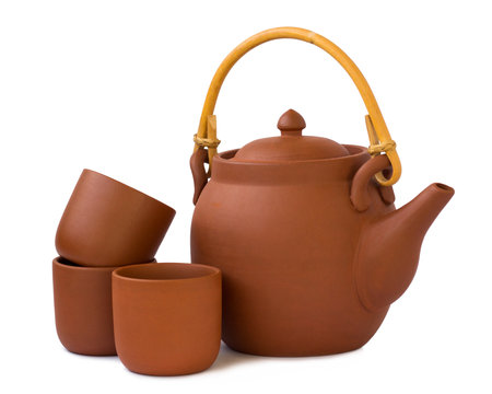 Clay teapot with cups isolated on white backgroundの写真素材