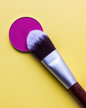 For Make-up. Bright shade with brush on a yellow backgroundの写真素材