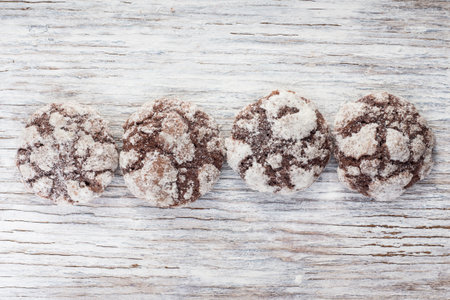 Chocolate cookies on light wooden background