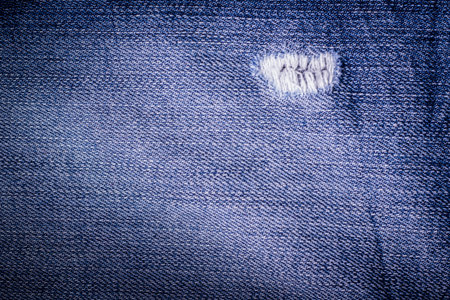 Jeans background. Texture. The holes in the fabric.の写真素材
