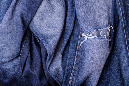 Jeans background. Texture. The holes in the fabric.の写真素材