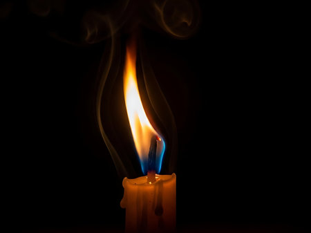 candle flame with smoke on black background, closeup of photoの素材