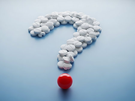 Question mark made of white pills and red ball on blue background.の素材
