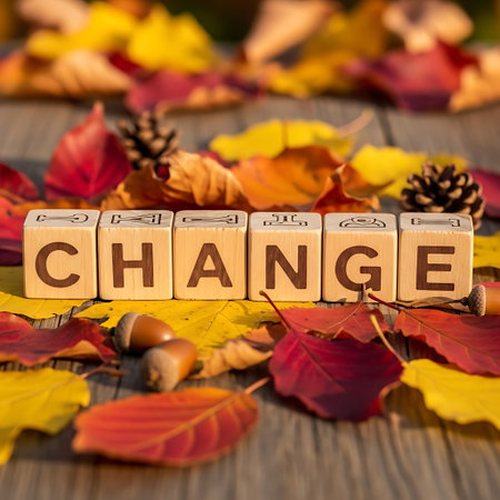 Wooden block spelling change surrounded by autumn leaf and acornの素材