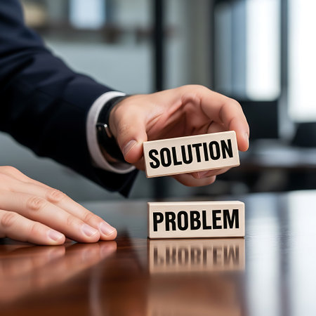 Businessman placing solution block on top of problem blockの素材