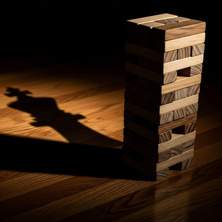 Wooden block tower casting a long shadow in dramatic lightの素材