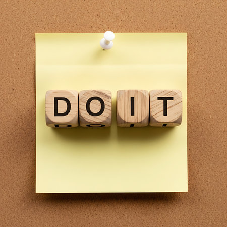 Wooden letter blocks spelling do it pinned to yellow sticky noteの素材