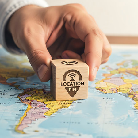 Hand placing wooden block with location pin and wifi symbol on mapの素材