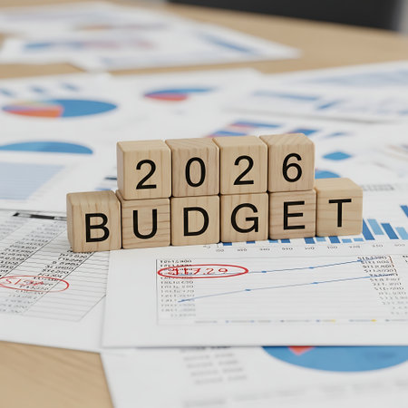 Wooden block spelling out 2026 budget on financial report paperの素材