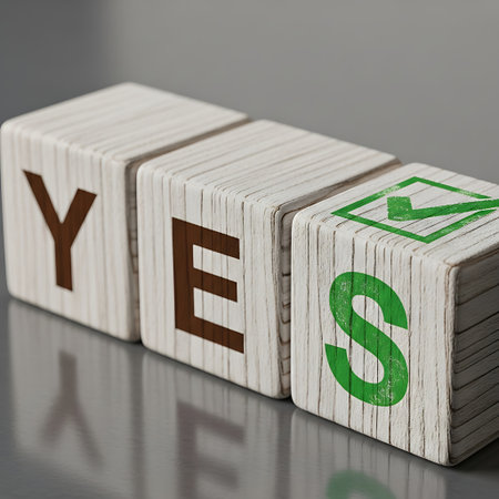 Wooden block spelling yes with check mark on last letterの素材