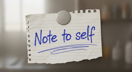 Torn piece of paper with handwritten note pinned on a surfaceの素材