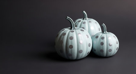 Three decorative pale blue pumpkins with silver accents on darkの素材