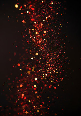 Abstract vertical stream of red and gold bokeh light particlesの素材