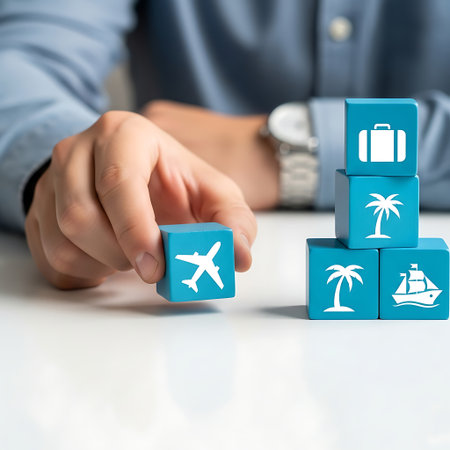 Hand placing travel block with airplane icon next to other vacation blocksの素材