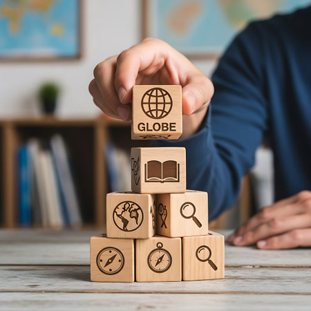Hand stacking wooden block with globe icon for global learningの素材