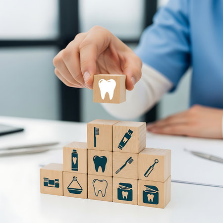 Dentist holding wooden block with tooth icon above other blocksの素材