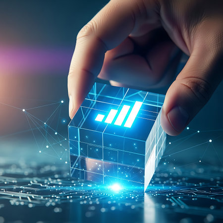 Hand placing glowing digital bar chart cube on circuit boardの素材