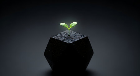 Small green sprout growing from dark soil in geometric shapeの素材