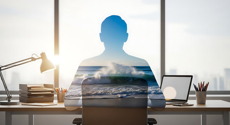 Double exposure of businessman silhouette and ocean wave at deskの素材