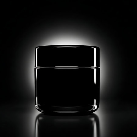 Black cosmetic jar mockup with glossy surface against dark backgroundの素材