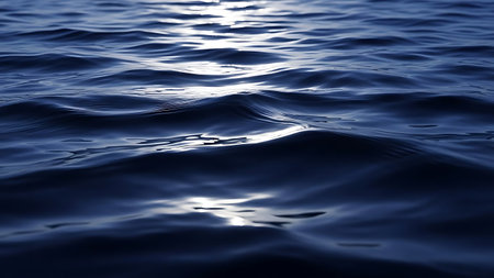 A serene image of ocean waves gently rippling on the water's surface, reflecting sunlight and creating a sense of tranquility.の素材
