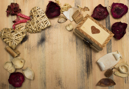 Gift box straw heart and a herbarium on a background of a wooden tableの写真素材