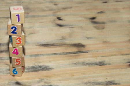 Cubes with colors numbers on old  wooden table backgroundの写真素材