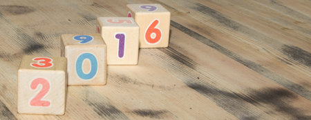 Cubes with colors numbers on old  wooden table backgroundの写真素材