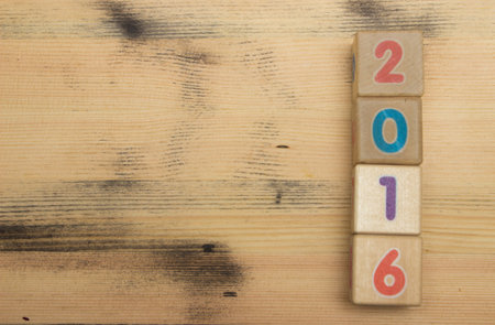 Cubes with colors numbers on old  wooden table backgroundの写真素材