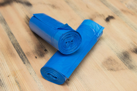 Roll of blue plastic garbage bags on wooden backgroundの写真素材
