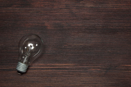 Creative energy and power of new ideas, innovation and creativity with hand holding bulb, retro toned image, selective focus.の写真素材