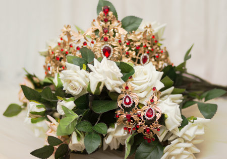 Bride golden crown with shining brilliants on rose flowers bouquetの写真素材
