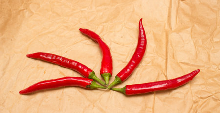 Red hot chili peppers on old brown paper sheet