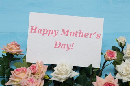 Mothers day card with rustic roses on blue wooden backgroundの写真素材