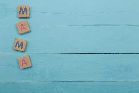 children's blocks with letters mother on a blue wooden backgroundの写真素材
