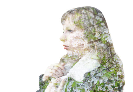 Double exposure portrait of young woman and blooming branch of cherryの写真素材