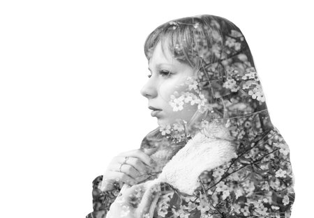 Black and white double exposure portrait of young woman and blooming branch of cherryの写真素材