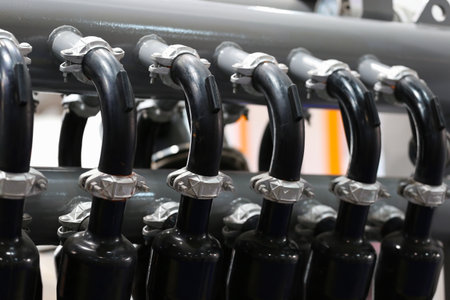 vertical black pipes for gas-filling station, indoorsの写真素材