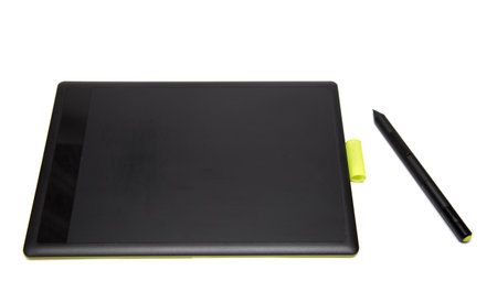 Top view of modern graphic tablet with pen isolated on white backgroundの写真素材