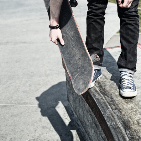 legs in blue shoes and the board skateboarder at the start. Close-up grunge styleの写真素材