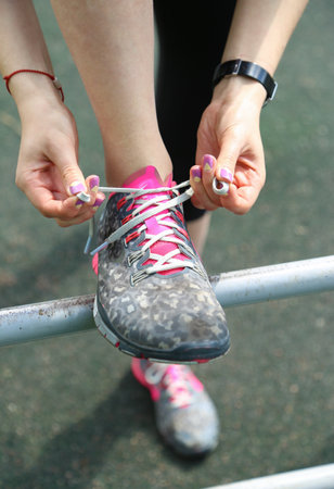 Sporty woman tie shoe laces, close up view. Running concept.の写真素材