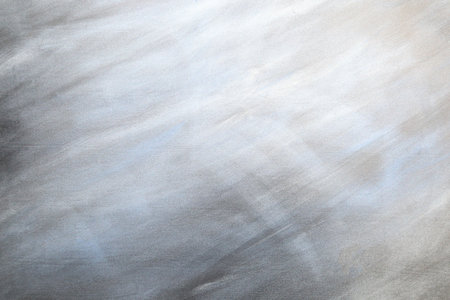 Light gray metal background with blue and white stains